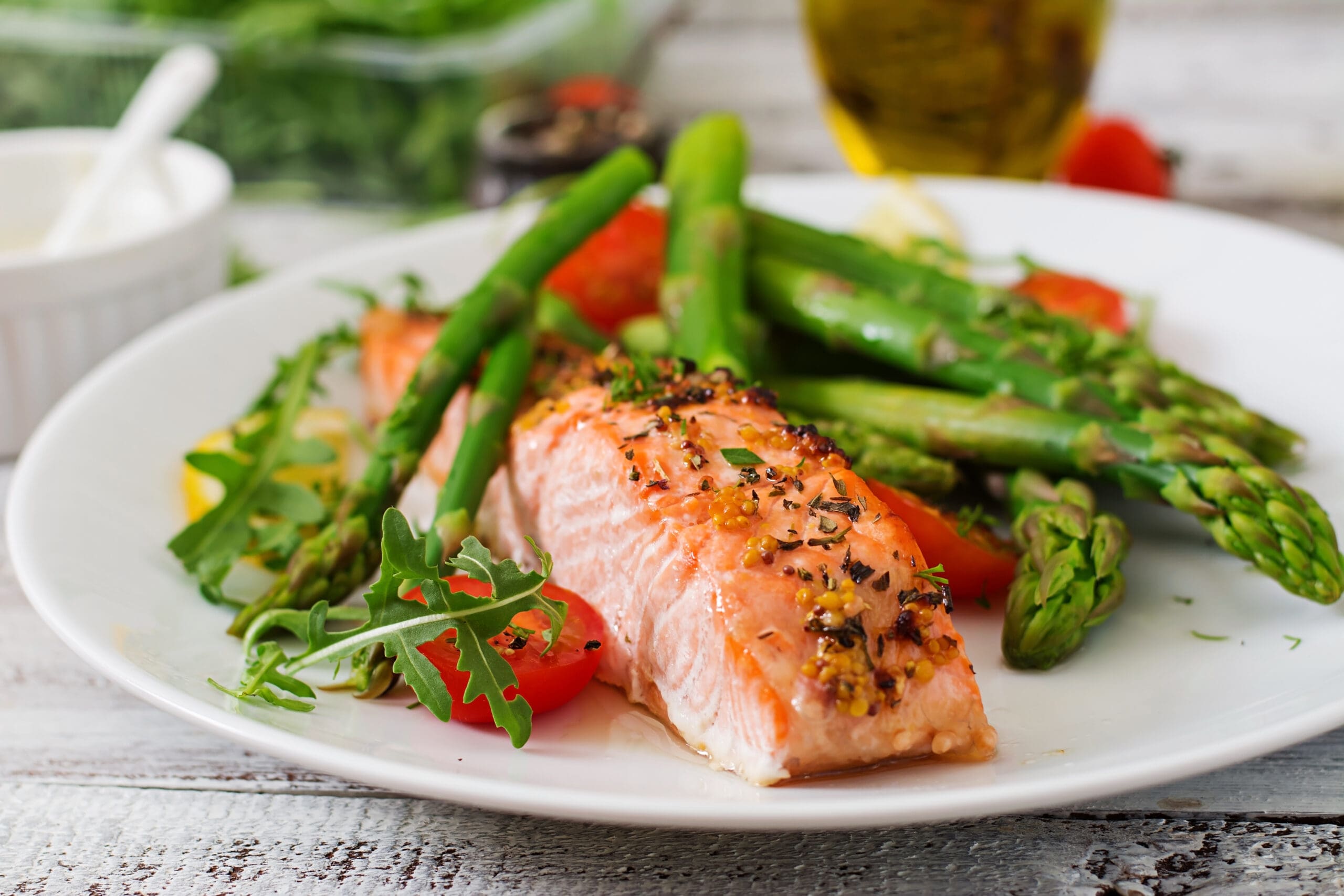 Plated salmon with asparagus and tomatoes served at a wedding vendor meal