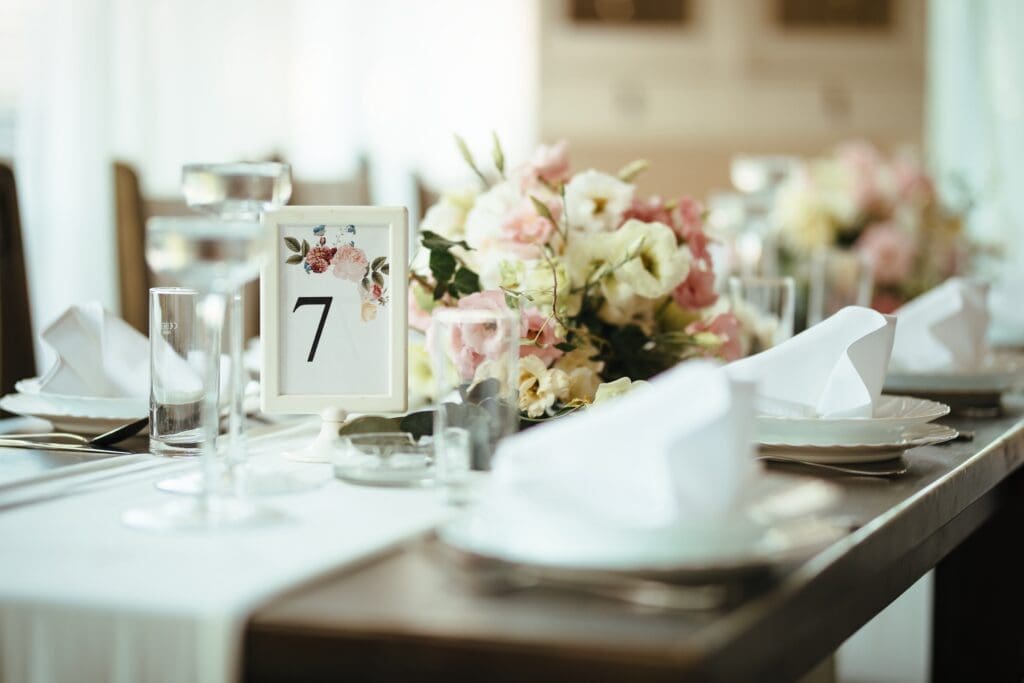 Elegant wedding reception table setting with floral centerpiece and candles