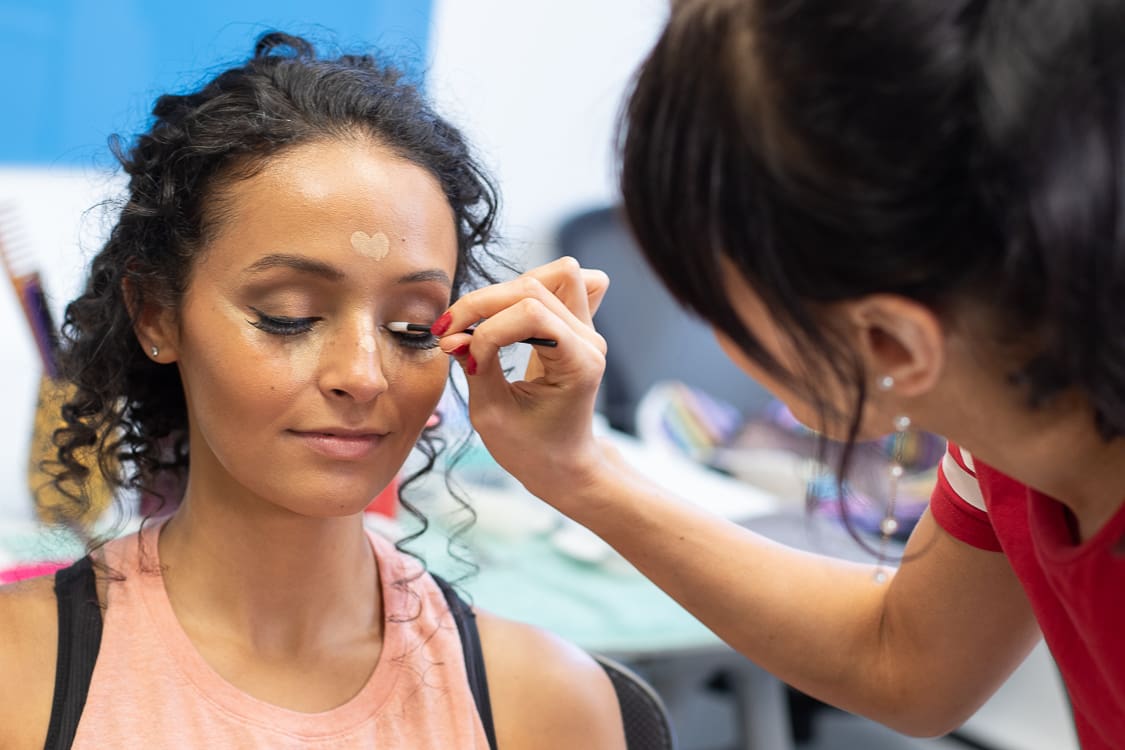 Bride meet s with professional makeup artist to preview makeup options before the wedding